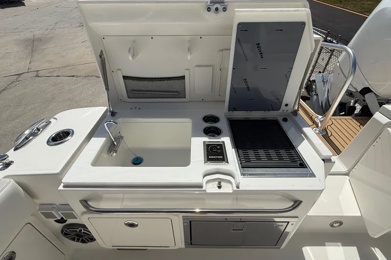 Slide: The Image of Outdoor kitchen on 2026 World Cat 400 DC-X Island boat with sink and grill. - 21