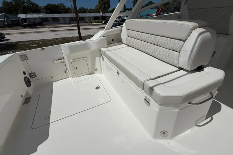 Slide: The Image of 2026 World Cat 400 DC-X Island boat interior with white cushioned seating. - 24