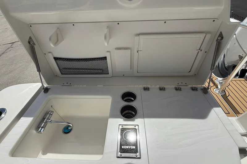 Slide: The Image of Outdoor sink and grill area on 2026 World Cat 400 DC-X Island boat. - 26
