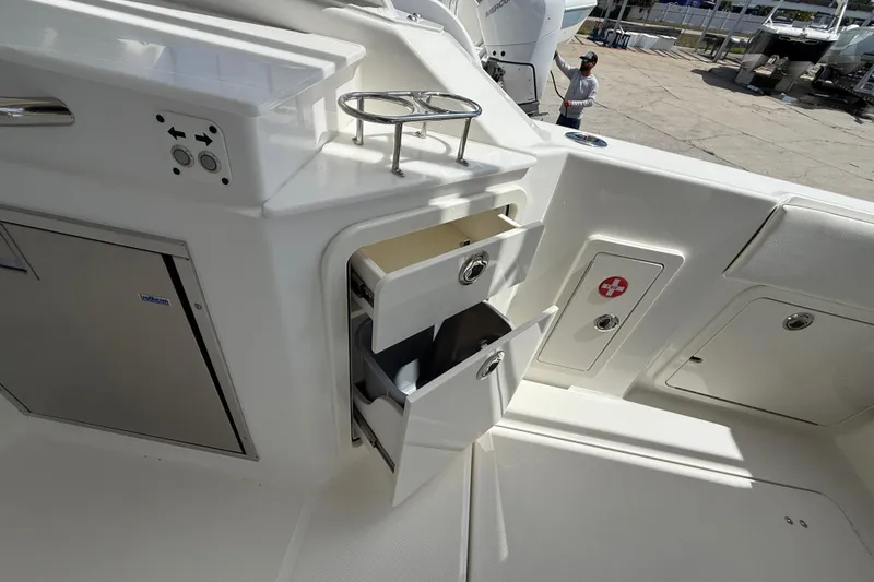 Slide: The Image of Interior of 2026 World Cat 400 DC-X Island boat with storage compartments open. - 28