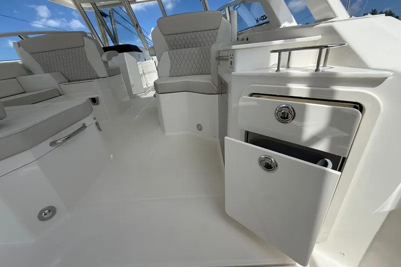 Slide: The Image of Luxurious interior of 2026 World Cat 400 DC-X Island boat with seating and storage. - 29
