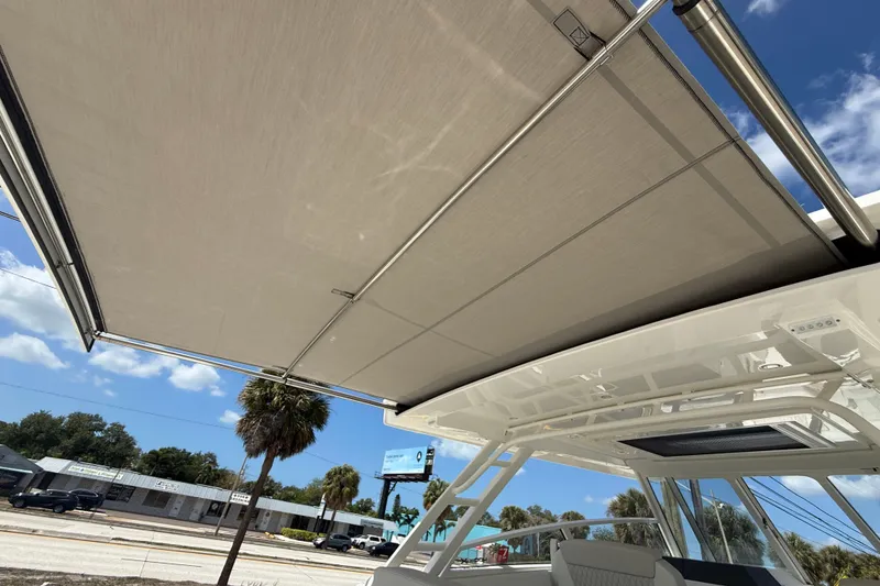 Slide: The Image of 2026 World Cat 400 DC-X Island boat with extended sunshade canopy. - 30