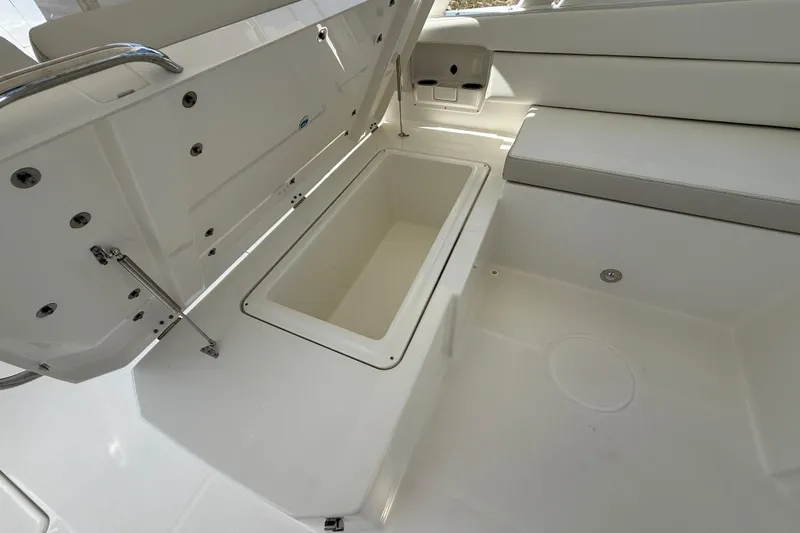 Slide: The Image of Open storage compartment on 2026 World Cat 400 DC-X Island boat interior. - 31