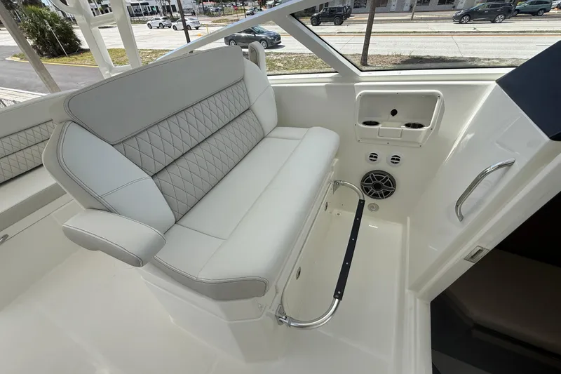 Slide: The Image of Luxurious seating on the 2026 World Cat 400 DC-X Island boat, featuring elegant design and comfort. - 32