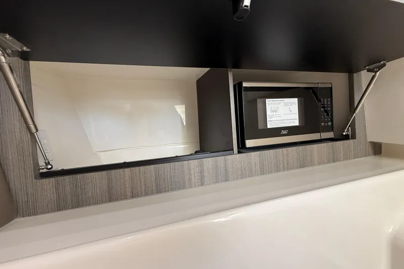 Slide: The Image of 2026 World Cat 400 DC-X Island boat interior with microwave in modern cabinetry. - 35