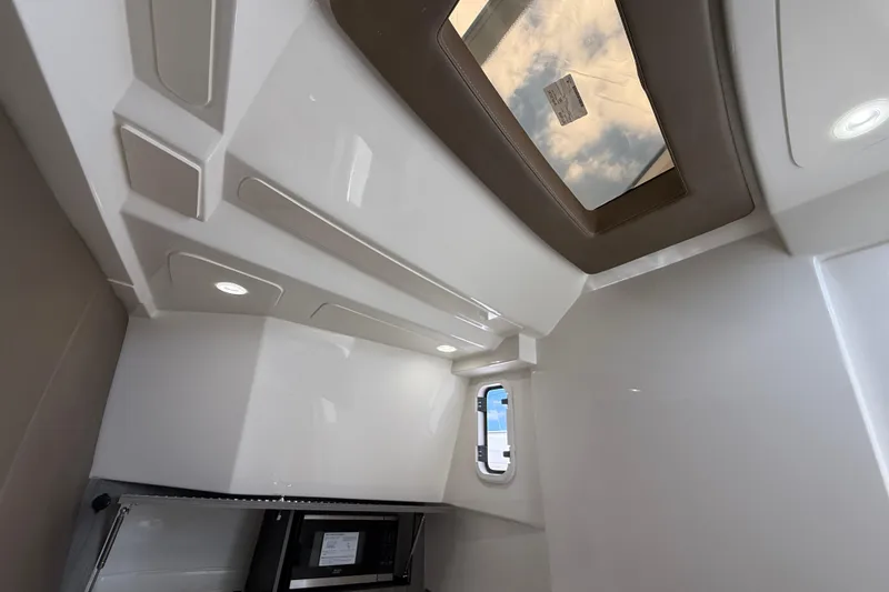 Slide: The Image of Interior view of 2026 World Cat 400 DC-X Island boat cabin with skylight and modern design. - 36