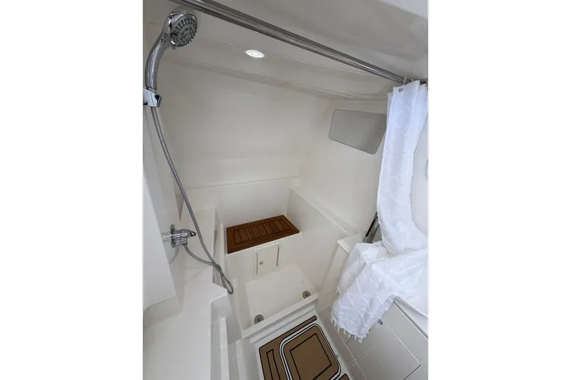 Slide: The Image of Modern shower area in 2026 World Cat 400 DC-X Island boat, featuring sleek design and wooden accents. - 40