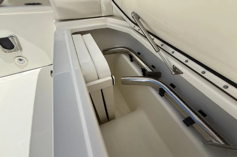 Slide: The Image of Storage compartment of 2026 World Cat 400 DC-X Island boat, featuring stainless steel fittings. - 44
