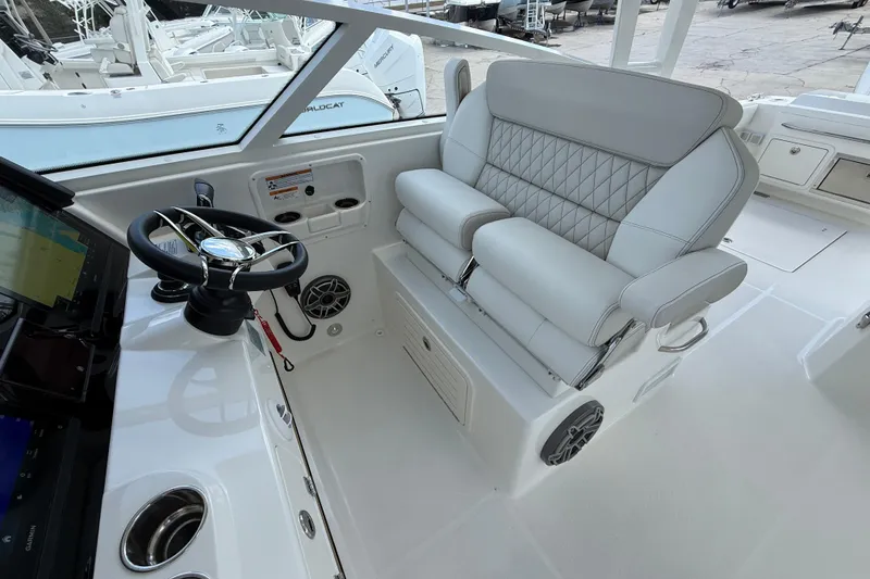 Slide: The Image of 2026 World Cat 400 DC-X Island boat interior with steering wheel and luxurious seating. - 48