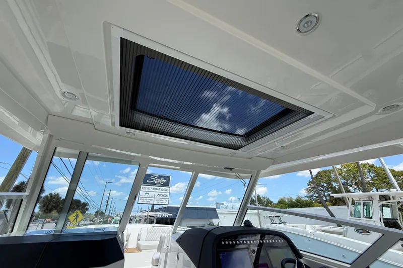 Slide: The Image of Interior view of 2026 World Cat 400 DC-X Island boat with sunroof and control panel. - 49