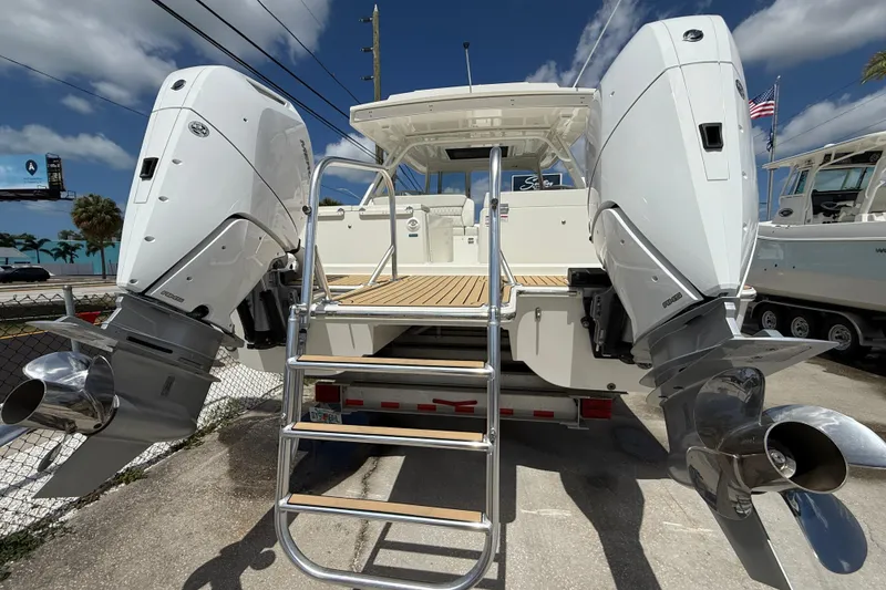 Slide: The Image of 2026 World Cat 400 DC-X Island boat with dual outboard engines and ladder. - 50