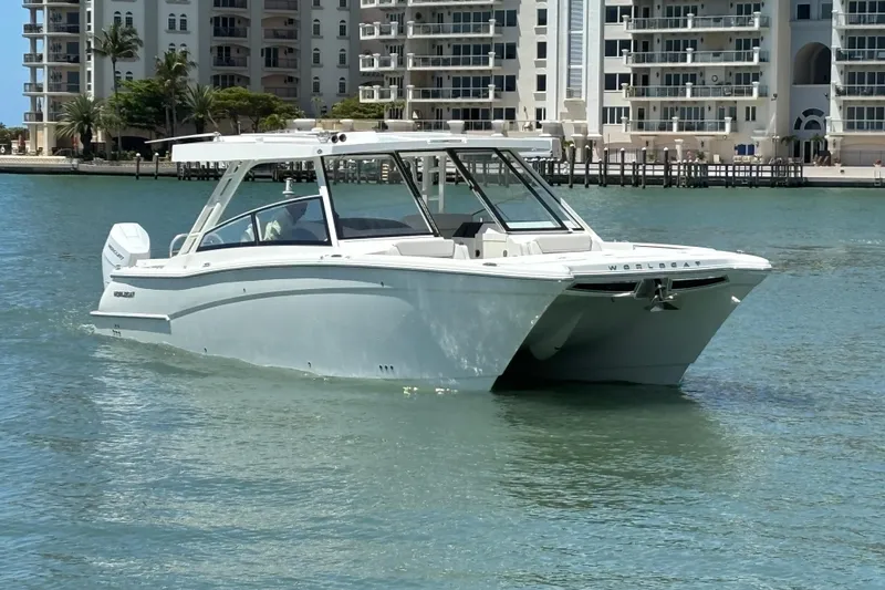 The Image of 2026 World Cat 400 DC-X Island catamaran cruising near waterfront buildings. - 8