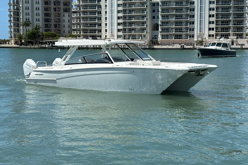 Slide: The Image of 2026 World Cat 400 DC-X Island boat on water, with city buildings in background. - 9
