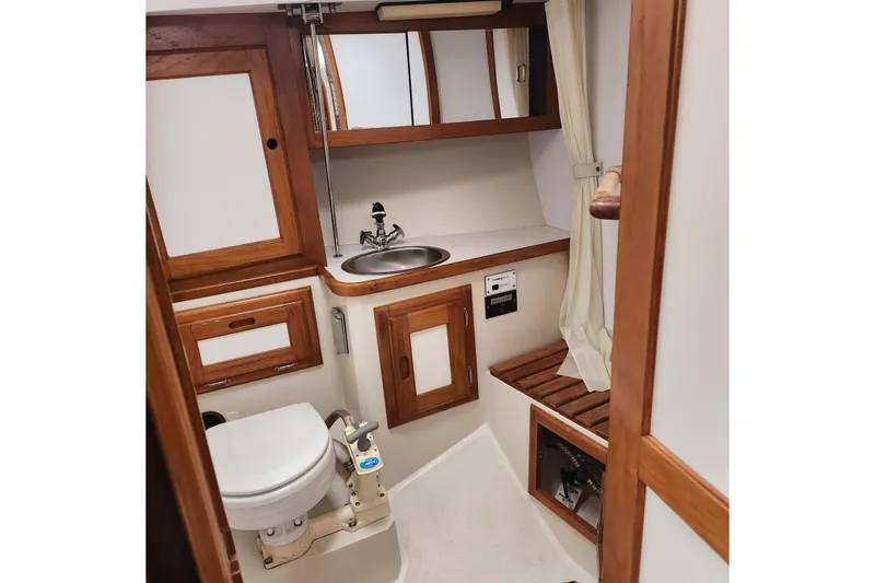 Slide: The Image of 1992 Catalina 36 yacht bathroom with wooden cabinetry and compact design. - 13