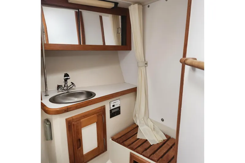 Slide: The Image of Interior of 1992 Catalina 36 sailboat bathroom with sink and wooden accents. - 15