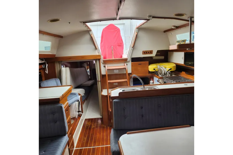 Slide: The Image of Interior of 1992 Catalina 36 sailboat with wood accents and cozy seating area. - 17