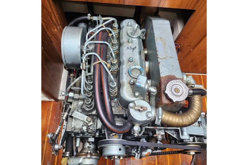 Slide: The Image of Engine of a 1992 Catalina 36 sailboat, showcasing mechanical components and hoses. - 18