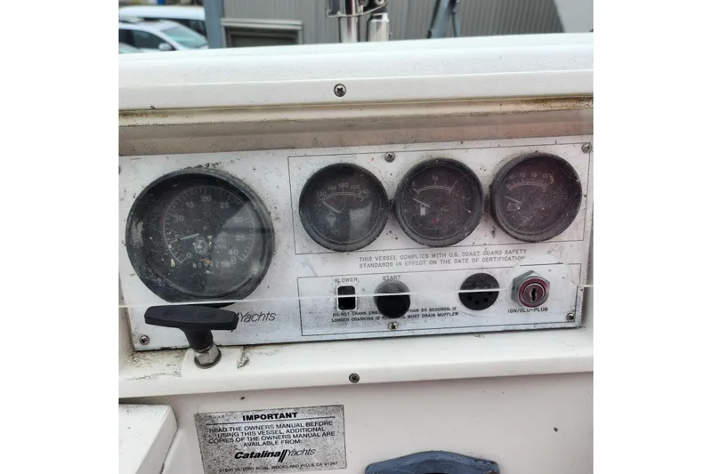 Slide: The Image of Instrument panel of a 1992 Catalina 36 yacht with gauges and safety instructions. - 19
