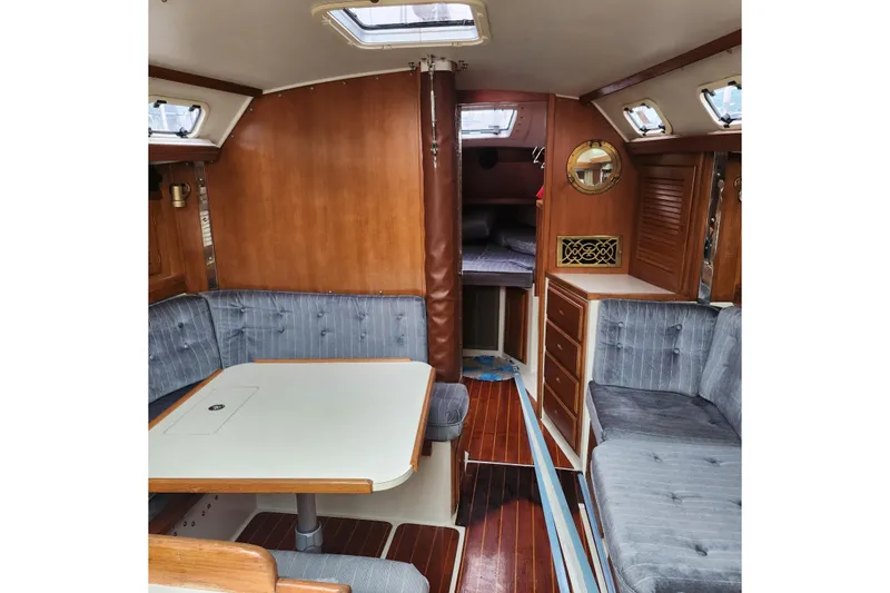 Slide: The Image of Interior of a 1992 Catalina 36 sailboat with cozy seating and wooden cabinetry. - 6