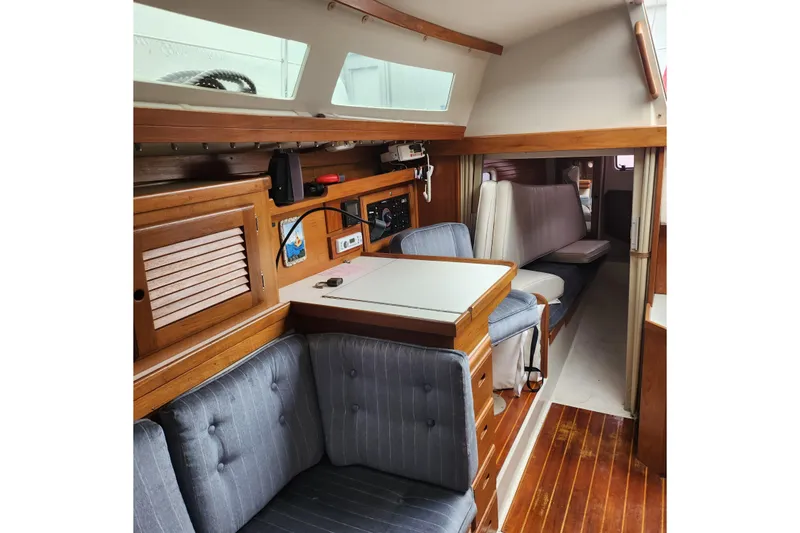 Slide: The Image of Interior of a 1992 Catalina 36 sailboat with wooden furnishings and seating area. - 8