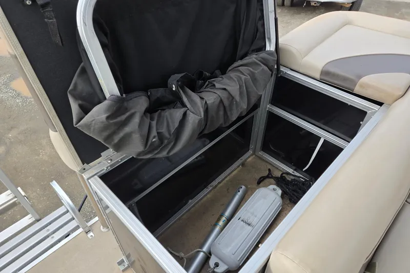 Slide: The Image of Open storage compartment in 2012 Berkshire 230 CL LSR boat, showing interior contents. - 10