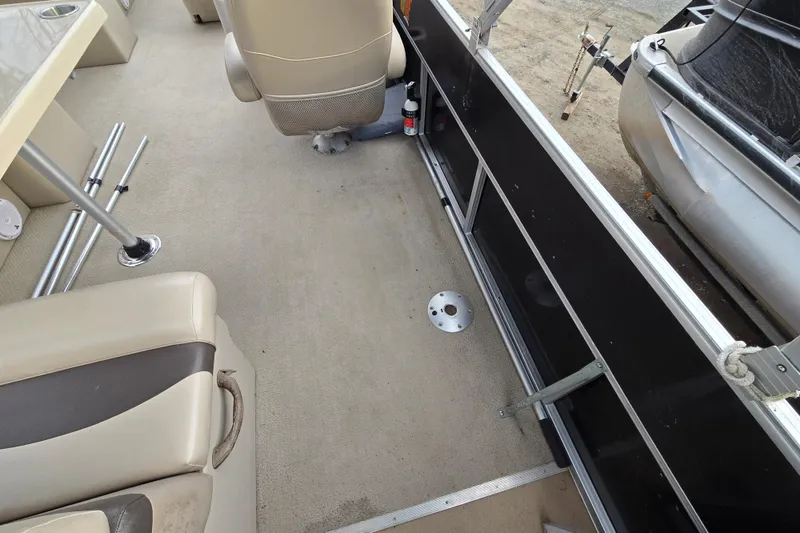 Slide: The Image of Interior of 2012 Berkshire 230 CL LSR pontoon boat with beige seating and carpeted floor. - 18