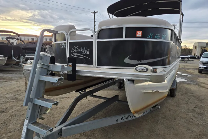 Slide: The Image of 2012 Berkshire 230 CL LSR pontoon boat on trailer at sunset. - 2