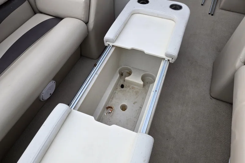 Slide: The Image of Interior of 2012 Berkshire 230 CL LSR boat showing storage compartment and cup holders. - 21