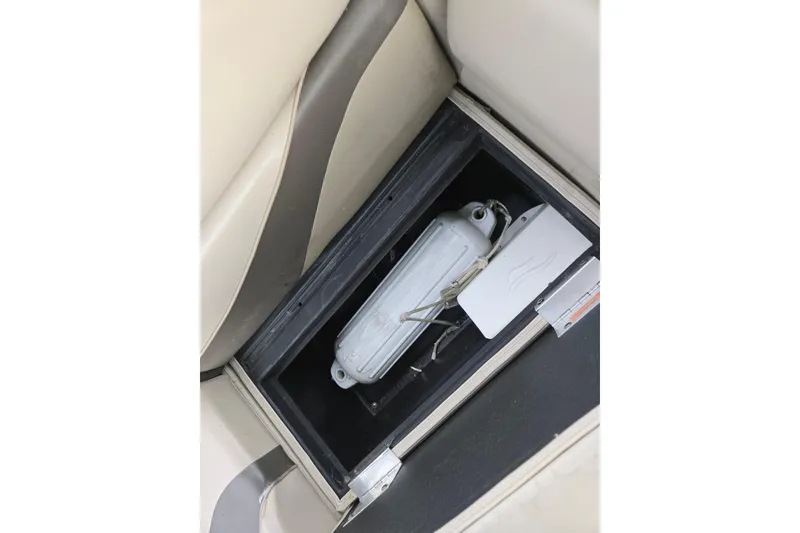 Slide: The Image of Storage compartment in a 2012 Berkshire 230 CL LSR boat, featuring a white container. - 27
