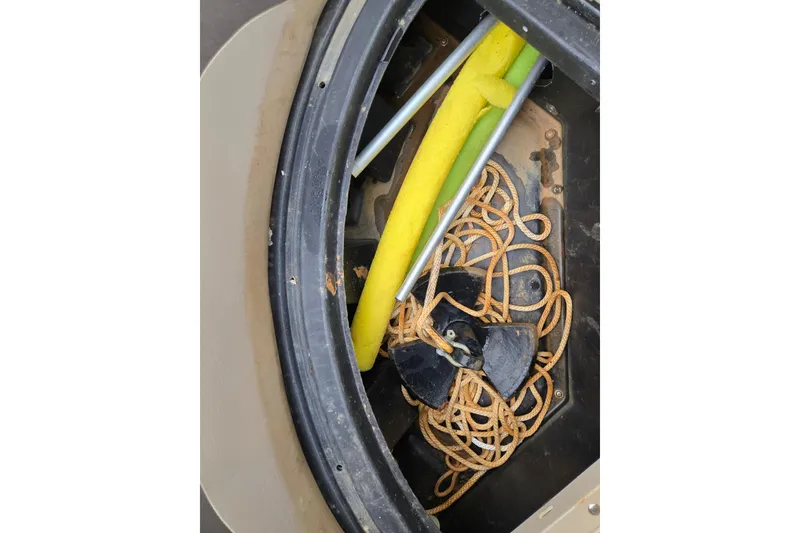 Slide: The Image of Storage compartment of a 2012 Berkshire 230 CL LSR with rope and pool noodles. - 28