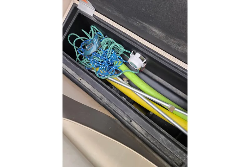 Slide: The Image of Storage compartment with ropes and tools in a 2012 Berkshire 230 CL LSR boat. - 29