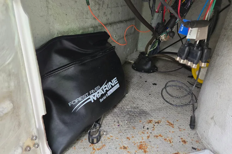 Slide: The Image of Interior of a 2012 Berkshire 230 CL LSR boat with wiring and a Forest River Marine bag. - 30