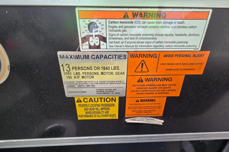 Slide: The Image of Safety and capacity warning labels on a 2012 Berkshire 230 CL LSR boat. - 31