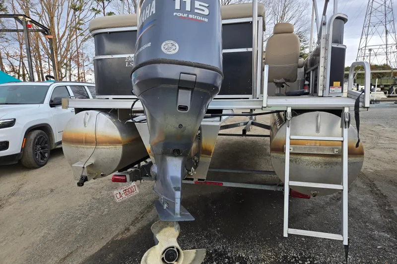 Slide: The Image of 2012 Berkshire 230 CL LSR pontoon boat with Yamaha 115 engine, parked on gravel. - 7