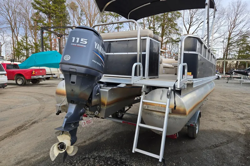Slide: The Image of 2012 Berkshire 230 CL LSR pontoon boat with Yamaha 115 engine, parked outdoors. - 8