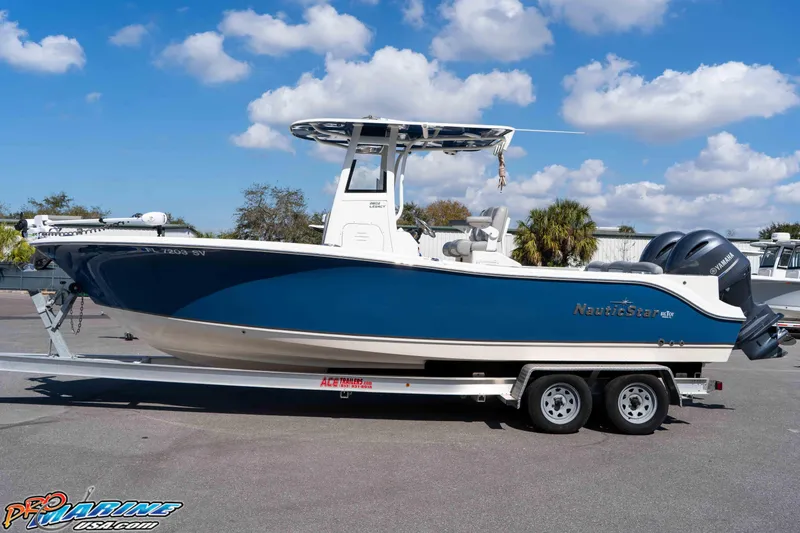 Slide: The Image of 2021 NauticStar 2602 Legacy boat on trailer under blue sky. - 10