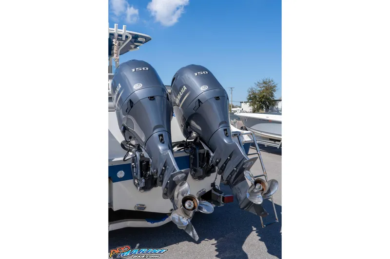 Slide: The Image of 2021 NauticStar 2602 Legacy with dual Yamaha 150 outboard motors. - 12