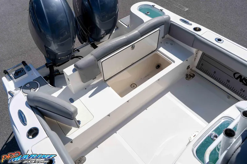 Slide: The Image of 2021 NauticStar 2602 Legacy boat interior with dual engines and seating area. - 21