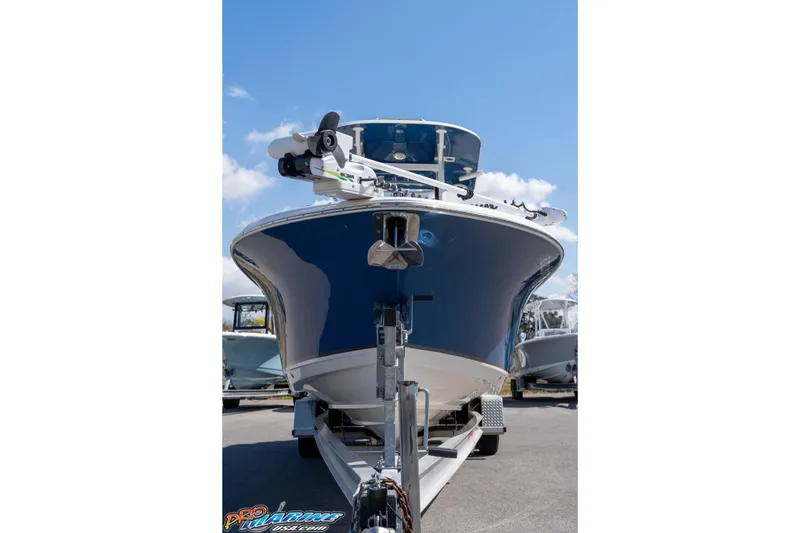 Slide: The Image of 2021 NauticStar 2602 Legacy boat on trailer under clear blue sky. - 3