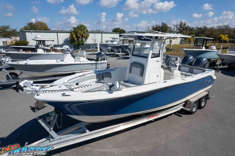 Slide: The Image of 2021 NauticStar 2602 Legacy boat on trailer, displayed outdoors under a clear sky. - 30