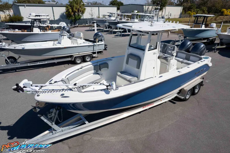 Slide: The Image of 2021 NauticStar 2602 Legacy boat on trailer, displayed in a marina setting. - 31