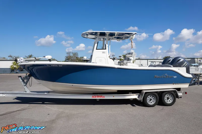 Slide: The Image of 2021 NauticStar 2602 Legacy boat on trailer under clear blue sky. - 32