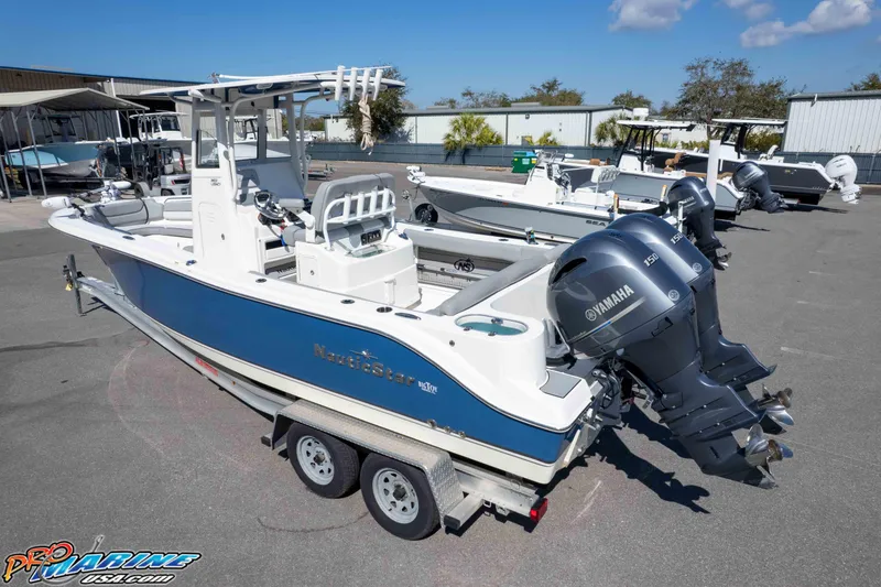 Slide: The Image of 2021 NauticStar 2602 Legacy boat with dual Yamaha engines on a trailer. - 36
