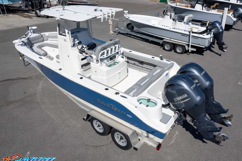 Slide: The Image of 2021 NauticStar 2602 Legacy boat with dual Yamaha engines on a trailer. - 37