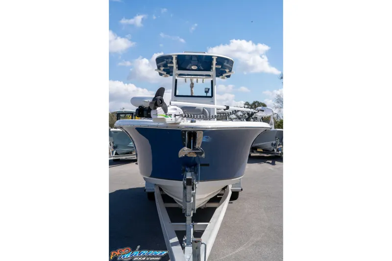 Slide: The Image of 2021 NauticStar 2602 Legacy boat on trailer under blue sky. - 4