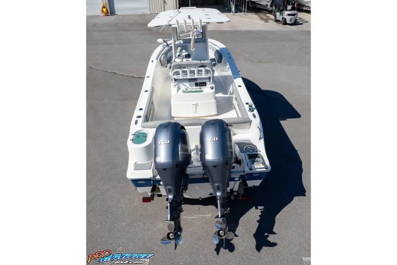 Slide: The Image of 2021 NauticStar 2602 Legacy boat with dual Yamaha 150 engines, viewed from the rear. - 40