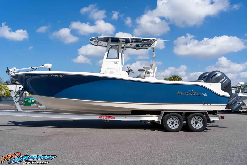 Slide: The Image of 2021 NauticStar 2602 Legacy boat on trailer under blue sky. - 9
