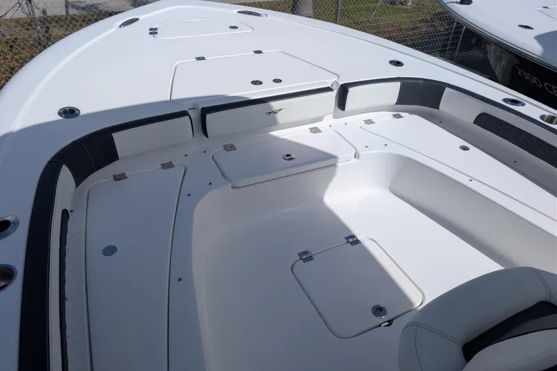 Slide: The Image of 2026 Tidewater 2300 Carolina Bay boat interior with storage compartments and seating. - 10