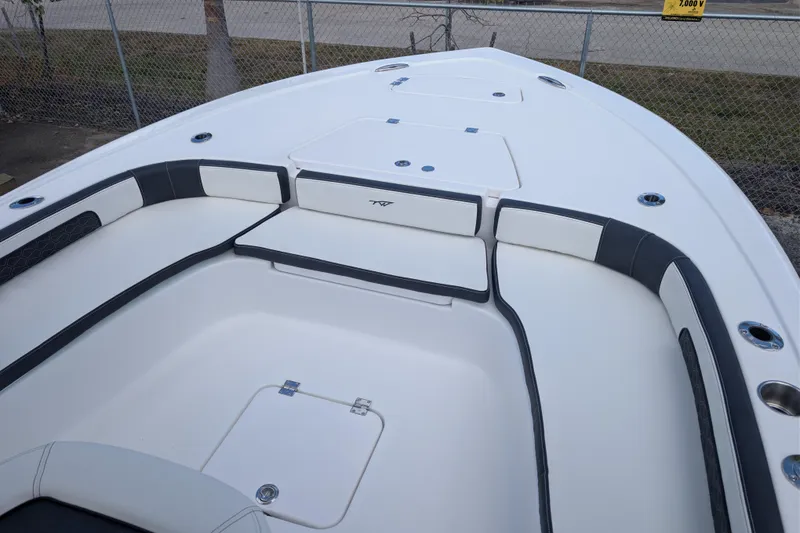Slide: The Image of 2026 Tidewater 2300 Carolina Bay boat interior with cushioned seating and storage compartments. - 15