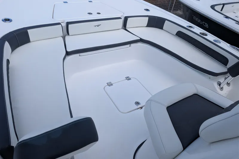Slide: The Image of 2026 Tidewater 2300 Carolina Bay boat interior with cushioned seating and storage compartments. - 18